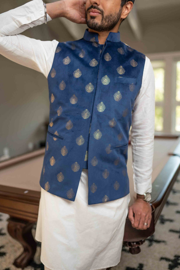 Light velvet, dark blue vest with silver peacock-shaped motifs. A modern twist on the vest with concealed/hidden buttons to offer a clean, seamless look 